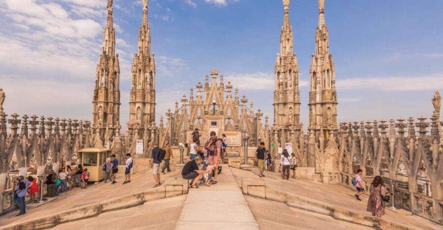 Milan: Cathedral Rooftop Tour - Duomo façade moments before you climb: statues, spires, and gargoyles